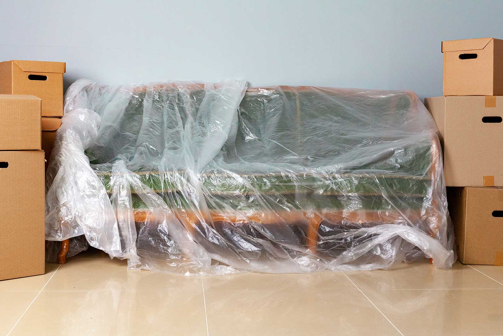 Furniture wrapped in protective covers inside a clean storage unit